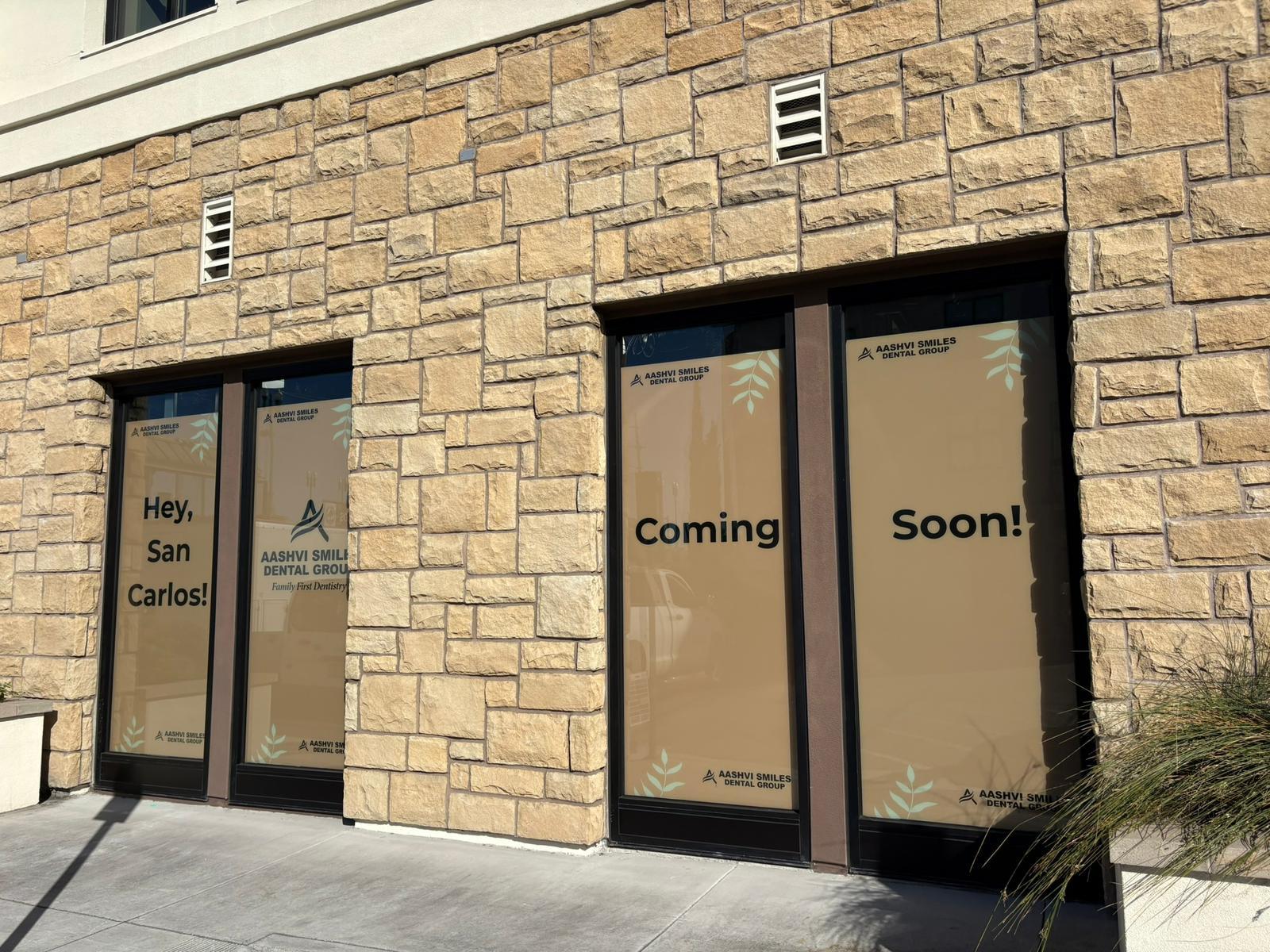 Aashvi Smiles Dental Group office windows with coming soon signage